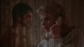 Movie still from “Star 80” (1983), directed by Bob Fosse – A woman talking on a phone next to a shirtless man; Close Up shot, Low angle