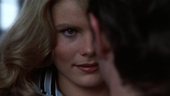 Movie still from “Star 80” (1983), directed by Bob Fosse – A woman's face with her hand touching her face; Close Up shot, Over the shoulder angle