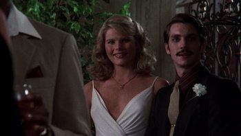 Movie still from “Star 80” (1983), directed by Bob Fosse – A woman in a white dress standing next to a man in a suit; Close Up shot, Low angle