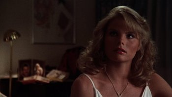 Movie still from “Star 80” (1983), directed by Bob Fosse – A woman with long blonde hair wearing a white top; Close Up shot, Over the shoulder angle