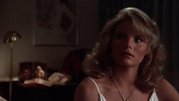 Movie still from “Star 80” (1983), directed by Bob Fosse – A woman with long blonde hair wearing a white top; Close Up shot, Low angle