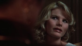 Movie still from “Star 80” (1983), directed by Bob Fosse – A beautiful blonde woman with a serious look; Close Up shot, Over the shoulder angle