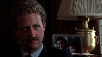 Movie still from “Star 80” (1983), directed by Bob Fosse – A person wearing a suit and tie; Close Up shot, Over the shoulder angle