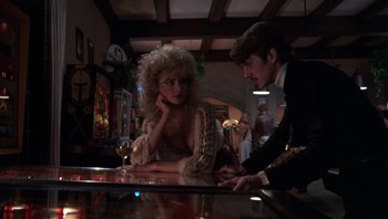 Movie still from “Star 80” (1983), directed by Bob Fosse – A man and a woman sitting at a bar; Medium shot, Low angle