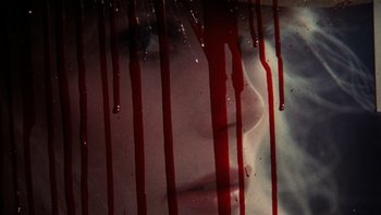 Movie still from “Star 80” (1983), directed by Bob Fosse – A woman's face with blood dripping down the side of her face; Extreme Close Up shot, Overhead angle