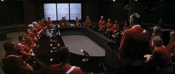 Movie still from “Star Trek VI: The Undiscovered Country” (1991), directed by Nicholas Meyer – A group of men sitting around a conference table; Extreme Wide shot, High angle