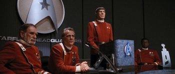 Movie still from “Star Trek VI: The Undiscovered Country” (1991), directed by Nicholas Meyer – Two men dressed in star trek uniforms sitting in front of a computer; Medium shot, Over the shoulder angle