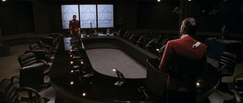 Movie still from “Star Trek VI: The Undiscovered Country” (1991), directed by Nicholas Meyer – A room that has a large table in the middle of the room; Extreme Wide shot, High angle