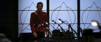 Movie still from “Star Trek VI: The Undiscovered Country” (1991), directed by Nicholas Meyer – A man in a star trek uniform standing in front of a mirror; Medium shot, Over the shoulder angle