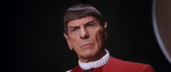 Movie still from “Star Trek VI: The Undiscovered Country” (1991), directed by Nicholas Meyer – A man in a red and white shirt and a black background; Close Up shot, Over the shoulder angle