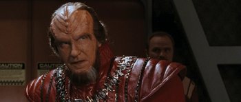Movie still from “Star Trek VI: The Undiscovered Country” (1991), directed by Nicholas Meyer – A person wearing a red jacket; Close Up shot, Over the shoulder angle