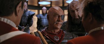 Movie still from “Star Trek VI: The Undiscovered Country” (1991), directed by Nicholas Meyer – A person wearing a mask; Medium shot, Over the shoulder angle