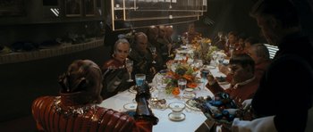 Movie still from “Star Trek VI: The Undiscovered Country” (1991), directed by Nicholas Meyer – A group of people sitting at a table with wine glasses; Wide shot, High angle