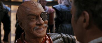 Movie still from “Star Trek VI: The Undiscovered Country” (1991), directed by Nicholas Meyer – A person wearing a mask with a eye patch; Close Up shot, Over the shoulder angle