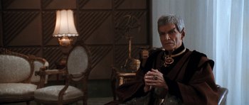 Movie still from “Star Trek VI: The Undiscovered Country” (1991), directed by Nicholas Meyer – An older man sitting on a chair in a living room; Medium shot, Over the shoulder angle