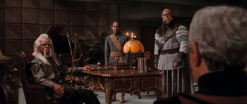 Movie still from “Star Trek VI: The Undiscovered Country” (1991), directed by Nicholas Meyer – A group of men standing around a table with candles on it; Wide shot, Over the shoulder angle
