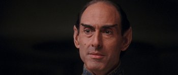 Movie still from “Star Trek VI: The Undiscovered Country” (1991), directed by Nicholas Meyer – A man's face in a dark room; Close Up shot, Over the shoulder angle