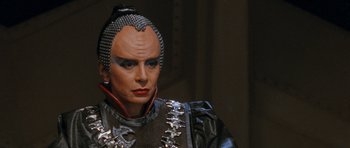Movie still from “Star Trek VI: The Undiscovered Country” (1991), directed by Nicholas Meyer – A man in a costume is looking at the camera; Close Up shot, Over the shoulder angle