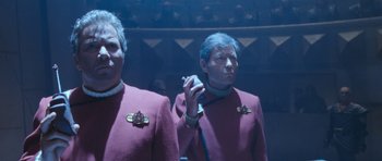 Movie still from “Star Trek VI: The Undiscovered Country” (1991), directed by Nicholas Meyer – Two men in purple jackets are standing next to each other; Medium shot, Low angle