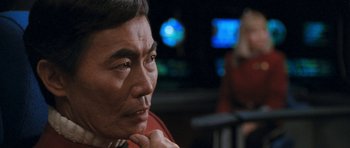 Movie still from “Star Trek VI: The Undiscovered Country” (1991), directed by Nicholas Meyer – An older man is sitting in front of a television; Close Up shot, Over the shoulder angle