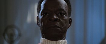 Movie still from “Star Trek VI: The Undiscovered Country” (1991), directed by Nicholas Meyer – A person wearing a sweater looking at the camera; Close Up shot, Low angle