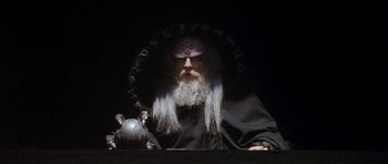 Movie still from “Star Trek VI: The Undiscovered Country” (1991), directed by Nicholas Meyer – An old man with long white hair wearing a black robe; Medium shot, Low angle