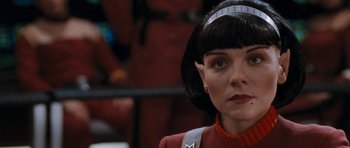 Movie still from “Star Trek VI: The Undiscovered Country” (1991), directed by Nicholas Meyer – An image of a woman in a red outfit; Close Up shot, Over the shoulder angle