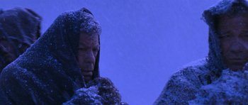 Movie still from “Star Trek VI: The Undiscovered Country” (1991), directed by Nicholas Meyer – A man with a beard and a hood covered in snow; Close Up shot, Over the shoulder angle