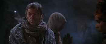Movie still from “Star Trek VI: The Undiscovered Country” (1991), directed by Nicholas Meyer – A man wearing a scarf and a sweater; Close Up shot, Over the shoulder angle