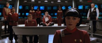 Movie still from “Star Trek VI: The Undiscovered Country” (1991), directed by Nicholas Meyer – A group of men and women dressed in star trek uniforms; Medium shot, Over the shoulder angle