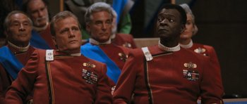 Movie still from “Star Trek VI: The Undiscovered Country” (1991), directed by Nicholas Meyer – A group of men in red and blue uniforms; Close Up shot, Over the shoulder angle