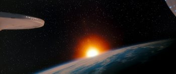 Movie still from “Star Trek VI: The Undiscovered Country” (1991), directed by Nicholas Meyer – A view of the sun setting over the earth from space; Extreme Wide shot, Overhead angle