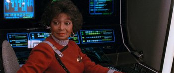 Movie still from “Star Trek VI: The Undiscovered Country” (1991), directed by Nicholas Meyer – A woman in a red shirt is in front of a computer screen; Close Up shot, Low angle