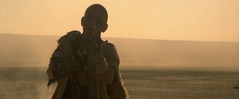 Movie still from “Star Trek V: The Final Frontier” (1989), directed by William Shatner – A man holding a rifle in his hands; Medium shot, Low angle