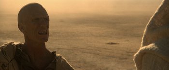 Movie still from “Star Trek V: The Final Frontier” (1989), directed by William Shatner – A person standing on a beach near the ocean; Close Up shot, Over the shoulder angle