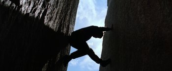 Movie still from “Star Trek V: The Final Frontier” (1989), directed by William Shatner – A man climbing up the side of a tree; Wide shot, Low angle