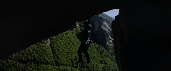 Movie still from “Star Trek V: The Final Frontier” (1989), directed by William Shatner – A man hanging from a rope on top of a cliff; Wide shot, High angle