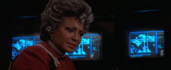 Movie still from “Star Trek V: The Final Frontier” (1989), directed by William Shatner – A person wearing a red shirt; Close Up shot, Over the shoulder angle