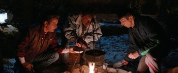 Movie still from “Star Trek V: The Final Frontier” (1989), directed by William Shatner – A group of people around a campfire cooking food; Medium shot, High angle