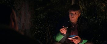 Movie still from “Star Trek V: The Final Frontier” (1989), directed by William Shatner – A man sitting at a table with a bowl of food; Close Up shot, Over the shoulder angle