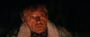 Movie still from “Star Trek V: The Final Frontier” (1989), directed by William Shatner – An older man with a white coat and a scarf around his neck; Close Up shot, Low angle