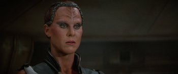 Movie still from “Star Trek V: The Final Frontier” (1989), directed by William Shatner – A person wearing a costume; Close Up shot, Over the shoulder angle