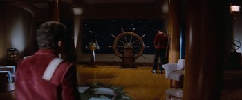 Movie still from “Star Trek V: The Final Frontier” (1989), directed by William Shatner – A man standing in front of a ship's steering wheel; Extreme Wide shot, High angle