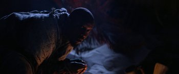 Movie still from “Star Trek V: The Final Frontier” (1989), directed by William Shatner – A man is kneeling down in the dark; Close Up shot, Low angle