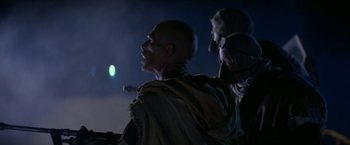 Movie still from “Star Trek V: The Final Frontier” (1989), directed by William Shatner – A man and a woman standing next to each other in the dark; Medium shot, Over the shoulder angle