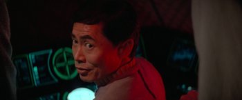 Movie still from “Star Trek V: The Final Frontier” (1989), directed by William Shatner – A person wearing a red shirt; Close Up shot, Over the shoulder angle