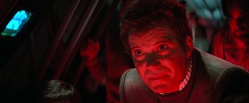 Movie still from “Star Trek V: The Final Frontier” (1989), directed by William Shatner – A person in a car with red lights; Close Up shot, Over the shoulder angle