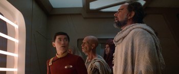 Movie still from “Star Trek V: The Final Frontier” (1989), directed by William Shatner – A group of men standing next to each other; Medium shot, Over the shoulder angle