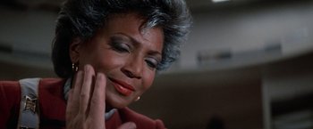 Movie still from “Star Trek V: The Final Frontier” (1989), directed by William Shatner – An older black woman with grey hair touching her face; Close Up shot, Over the shoulder angle