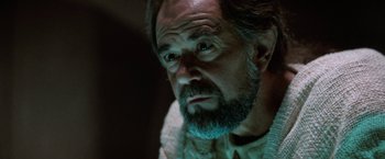 Movie still from “Star Trek V: The Final Frontier” (1989), directed by William Shatner – A person with a beard; Close Up shot, Over the shoulder angle